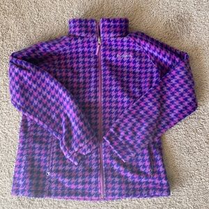 Fleece zip up. Has pockets and a pop collar.